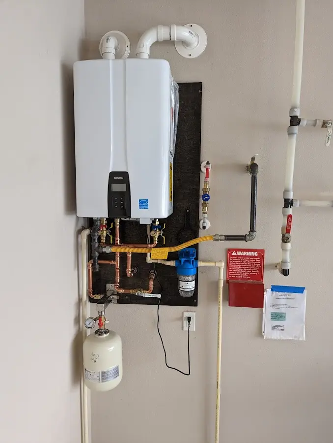 Professional plumber installing copper piping in a Atchison home